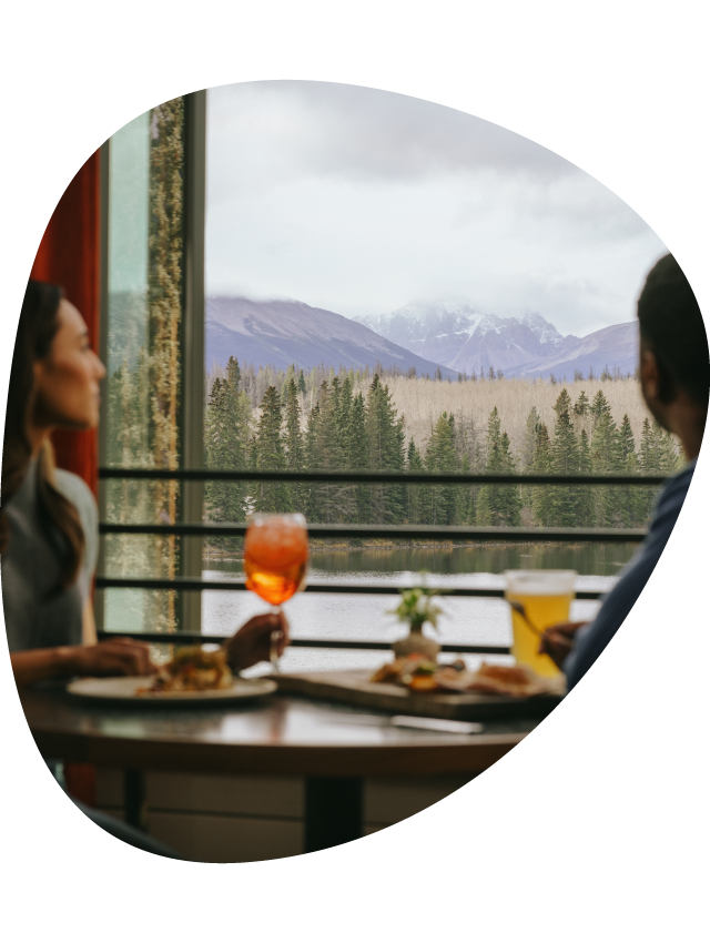 A couple dine at Aalto while looking out a window to Pyramid Lake.