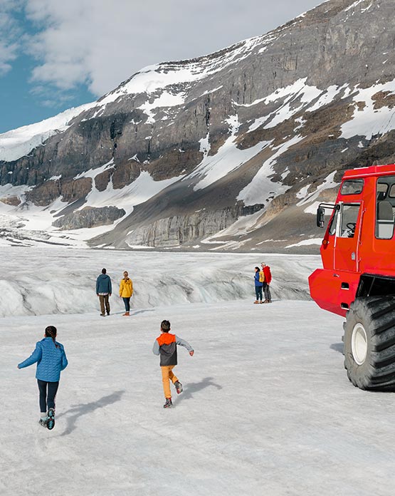 A family running on a glacier.