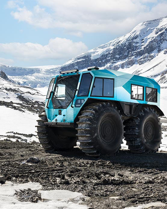 A small Sherp vehicle on a rocky path between ice