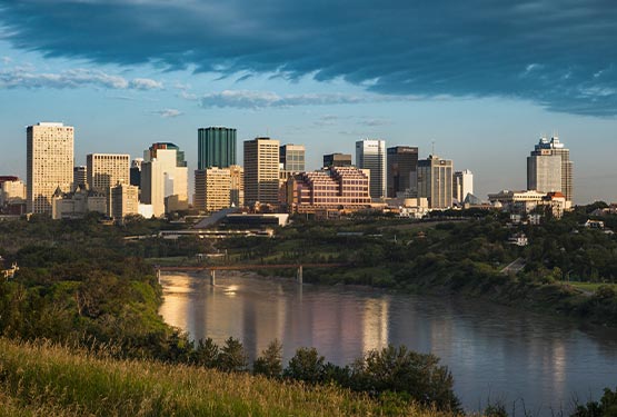 The Edmonton skyline, showing a view of skyscrapers and a wide river.