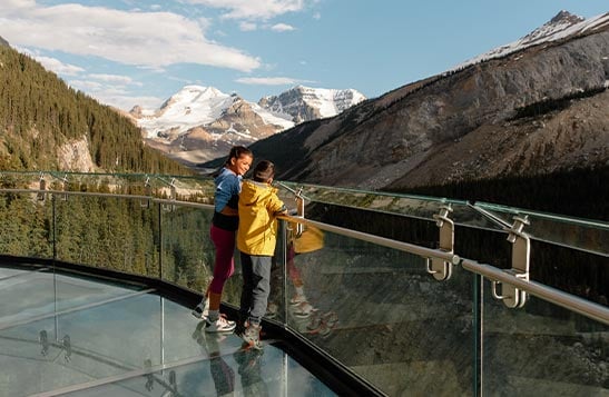 Two boys look out to the mountains from the Icefield Skywalk