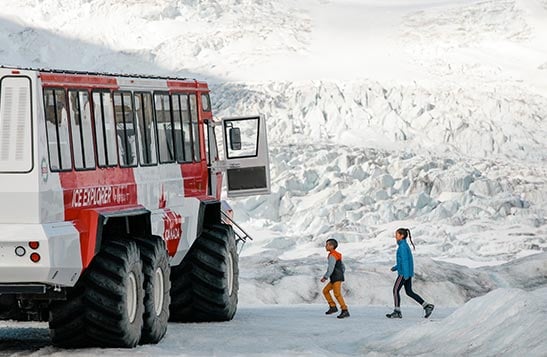 A family stands on a glacier.