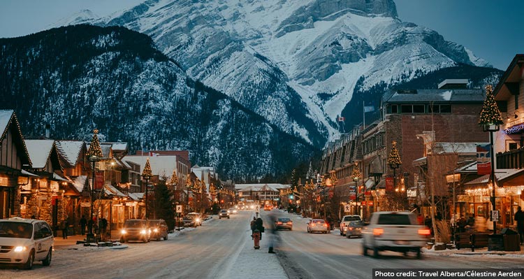 A view down Banff Avenue looking towards a tall snow-covered mountain.