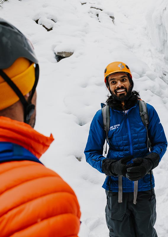 Two people with an icewalk guide.