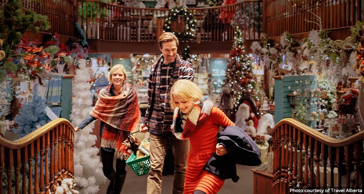 A family walking through a store of Christmas decorations.