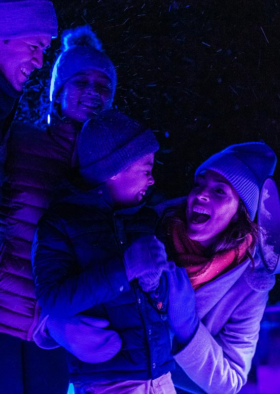 A family happy together at the Nightrise event at the Banff Gondola