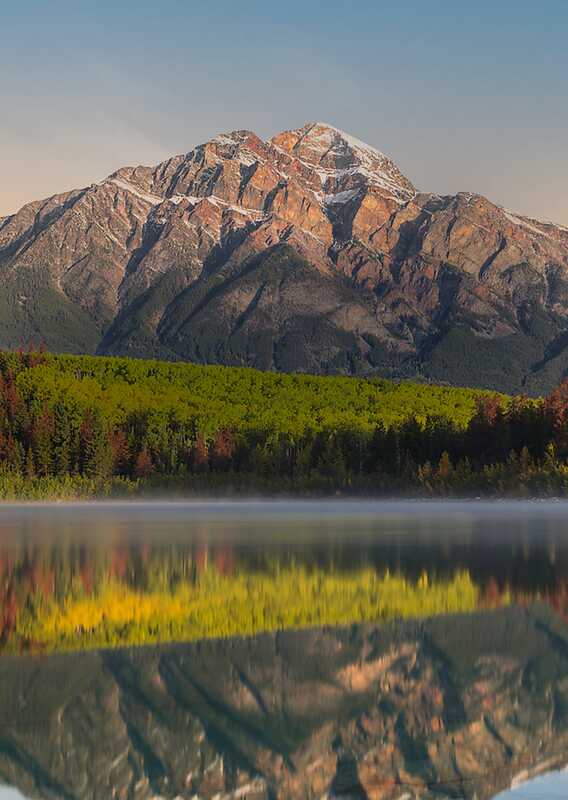 A mountain high above a lake.