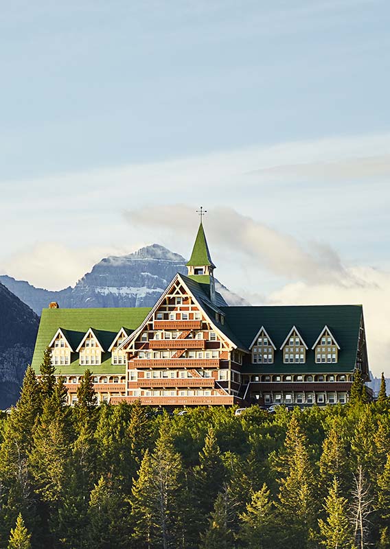 The Prince of Wales Hotel photographed between the mountains and trees