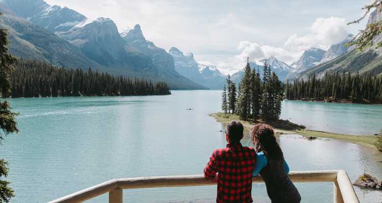 Couple looking at the mountain view at Maligne Lake