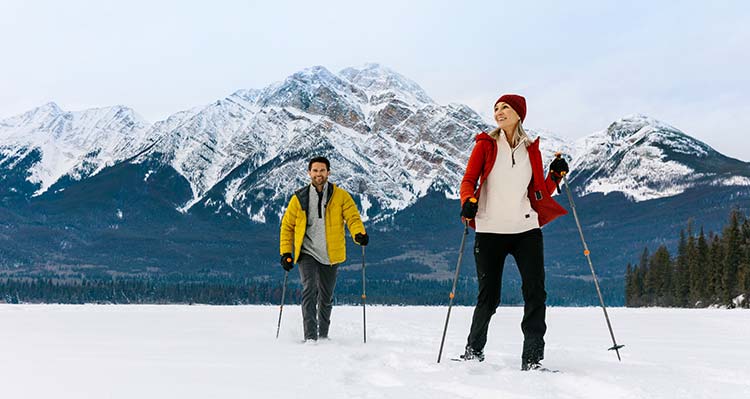 A man and woman snowshoeing on Pyramid Lake.