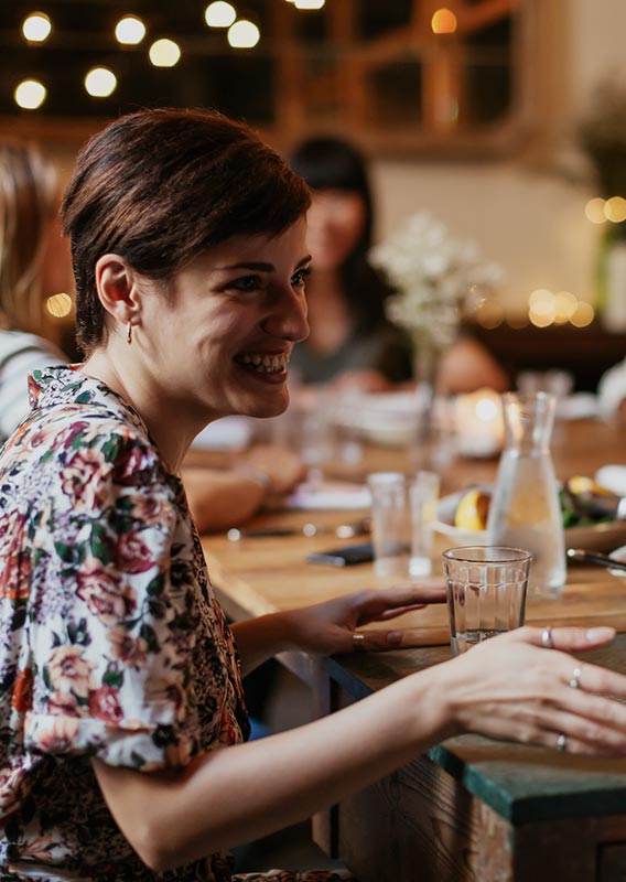 Two people sit at a table in discussion.