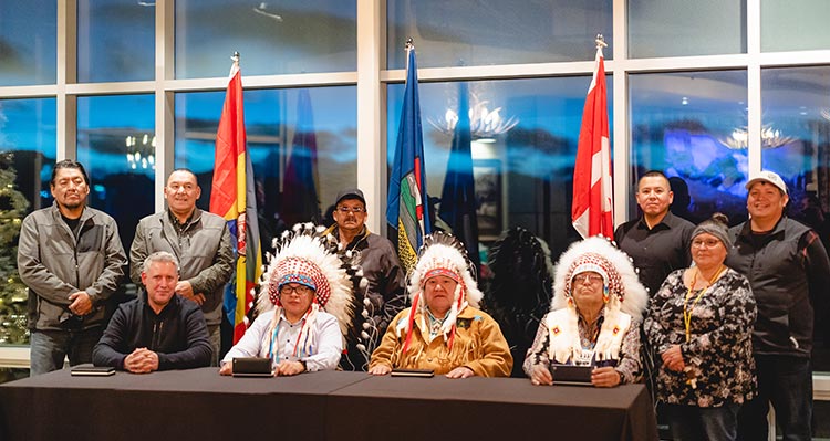 A group of First Nations leaders meeting with a businessman.