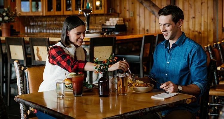 Two people have dinner in a restaurant.