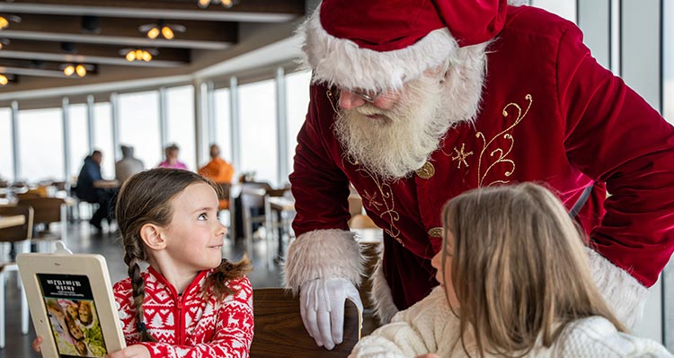 Santa Claus at an activity station with childen.