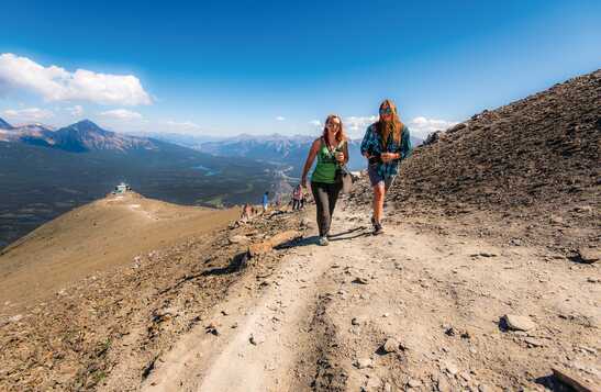 Two people hiking a mountain in Jasper